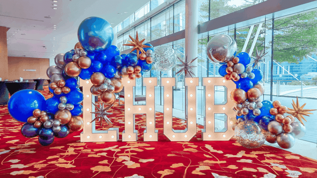 corporate-event-planner-singapore-seminar-decor Corporate event planner Singapore setting up seminar event decor with marquee letters